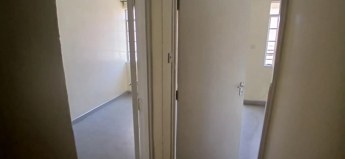 Bright corridor with multiple doorways and natural light