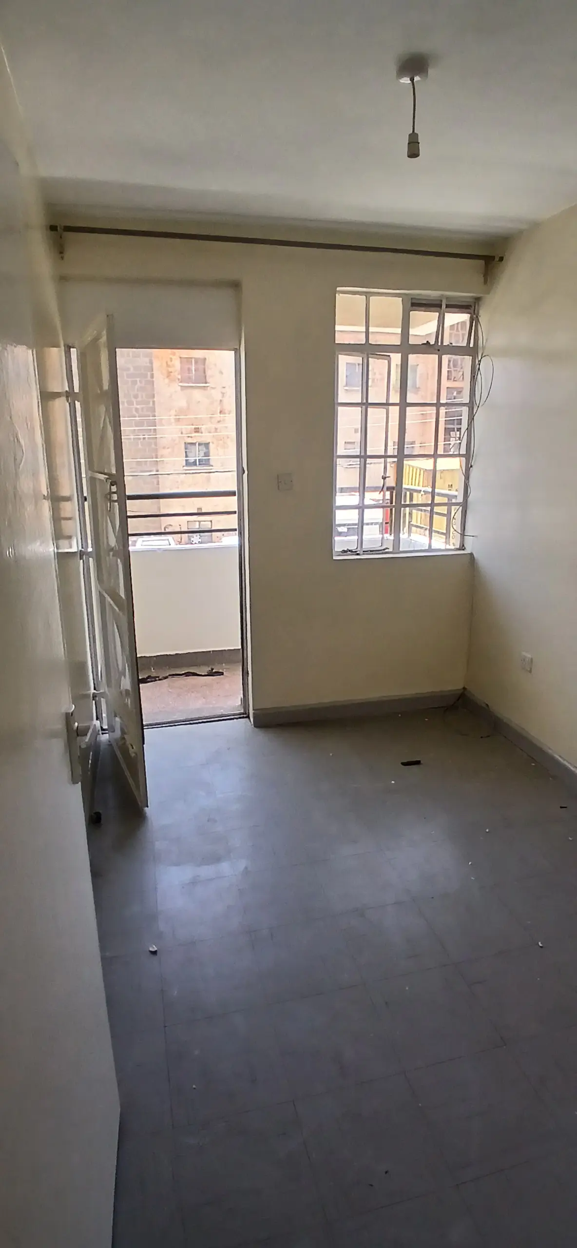 Unfurnished bedroom with balcony access and natural light