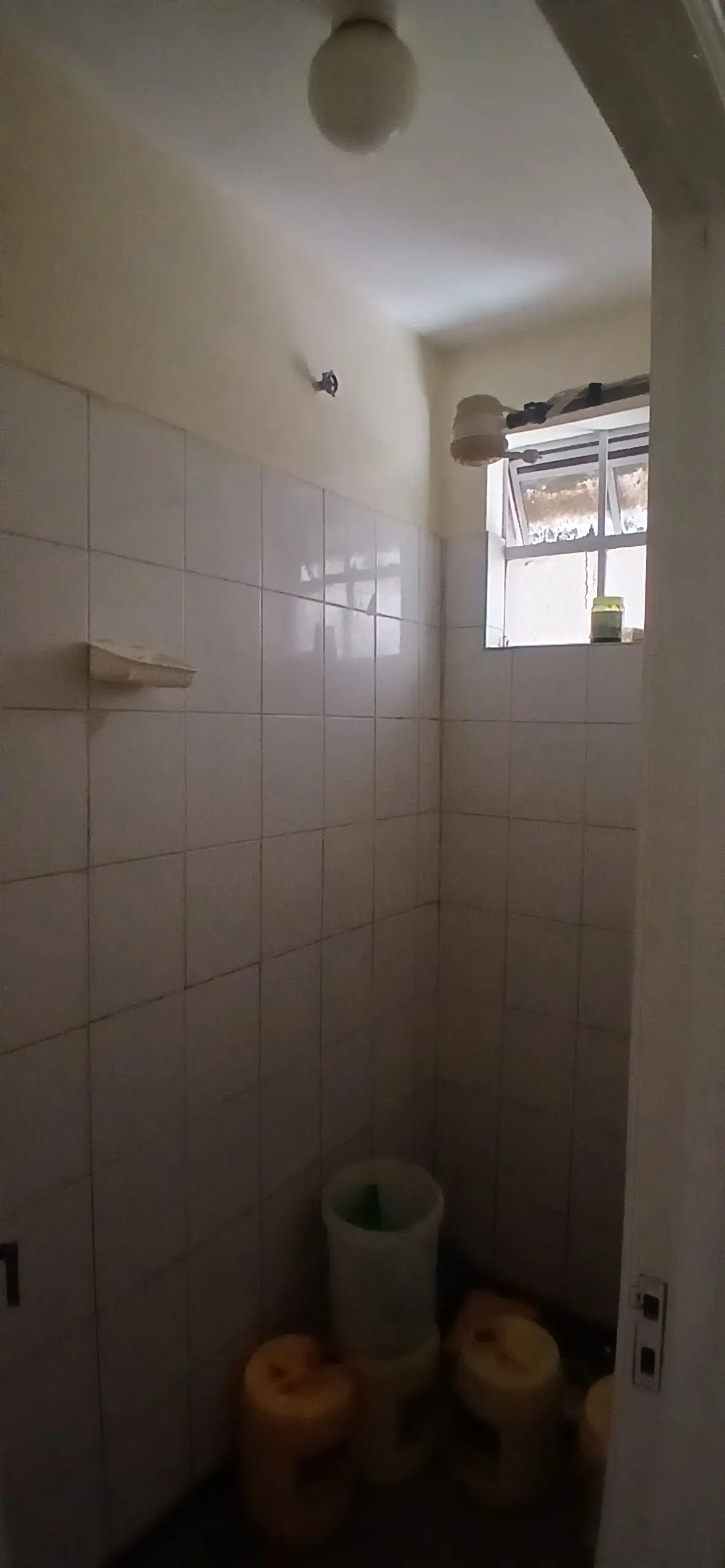 Compact bathroom with shower enclosure and overhead showerhead