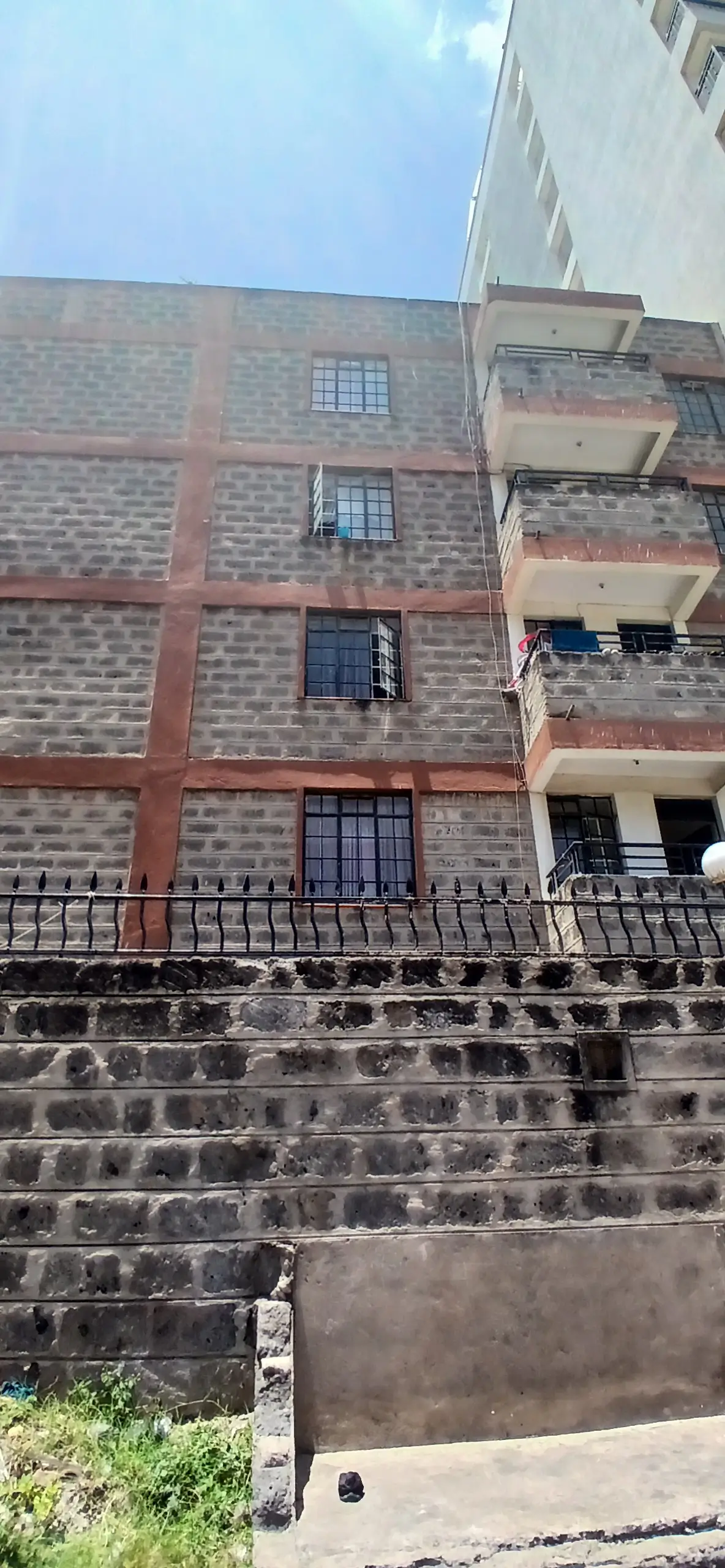 Multi-story residential building facade with brick and stone finish
