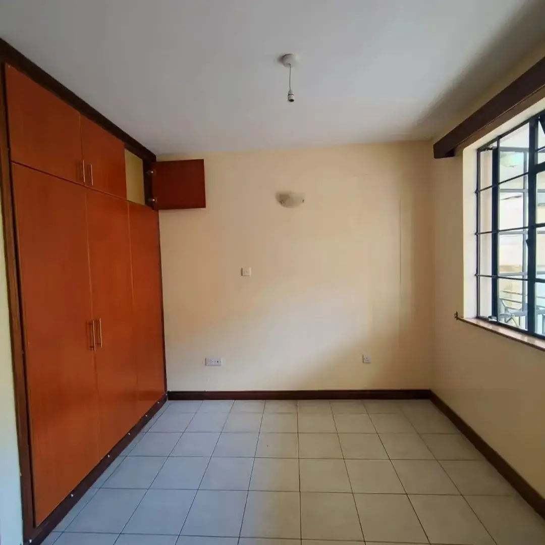 Spacious bedroom with built-in wardrobe and natural light