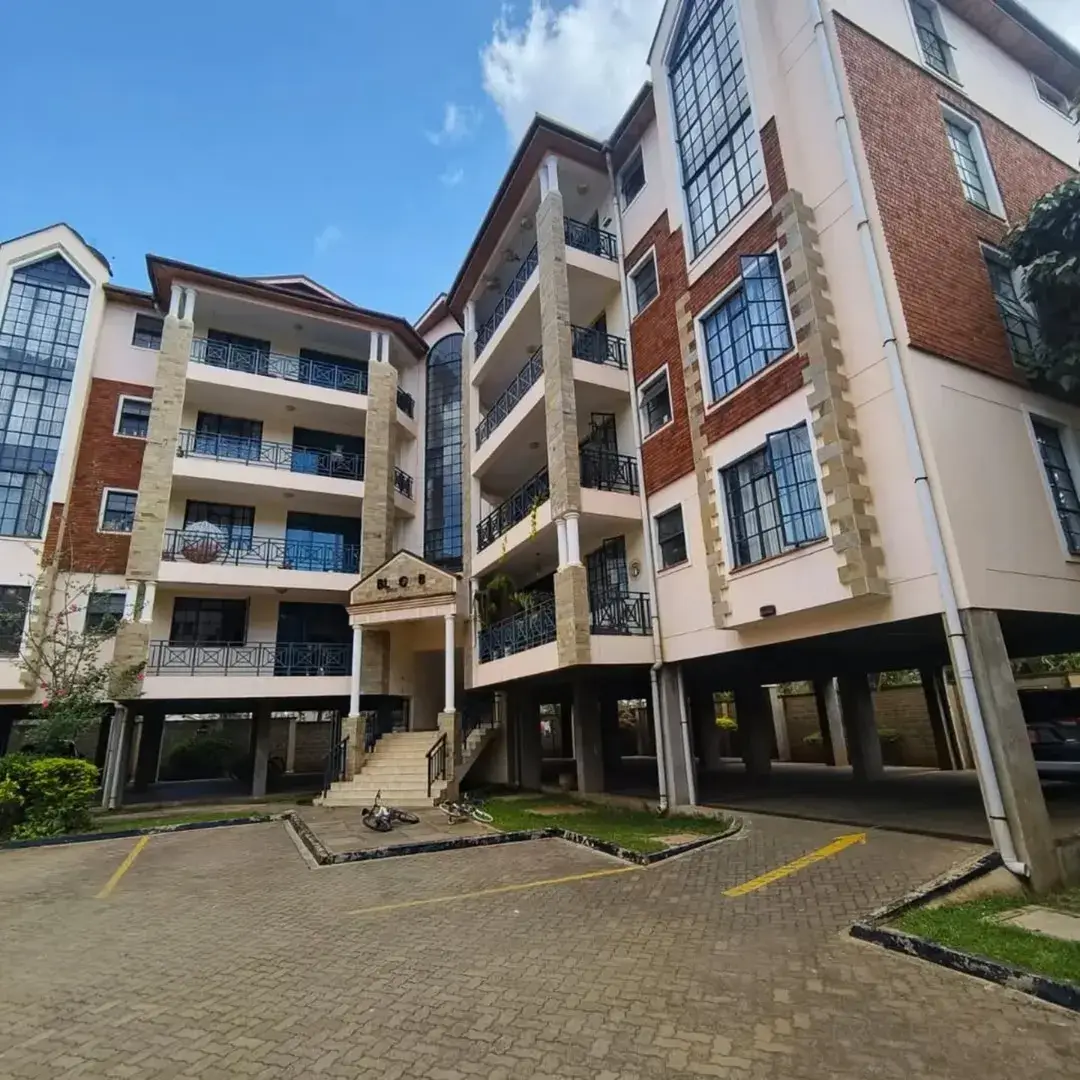 Modern multi-story residential building with brick and cream facade