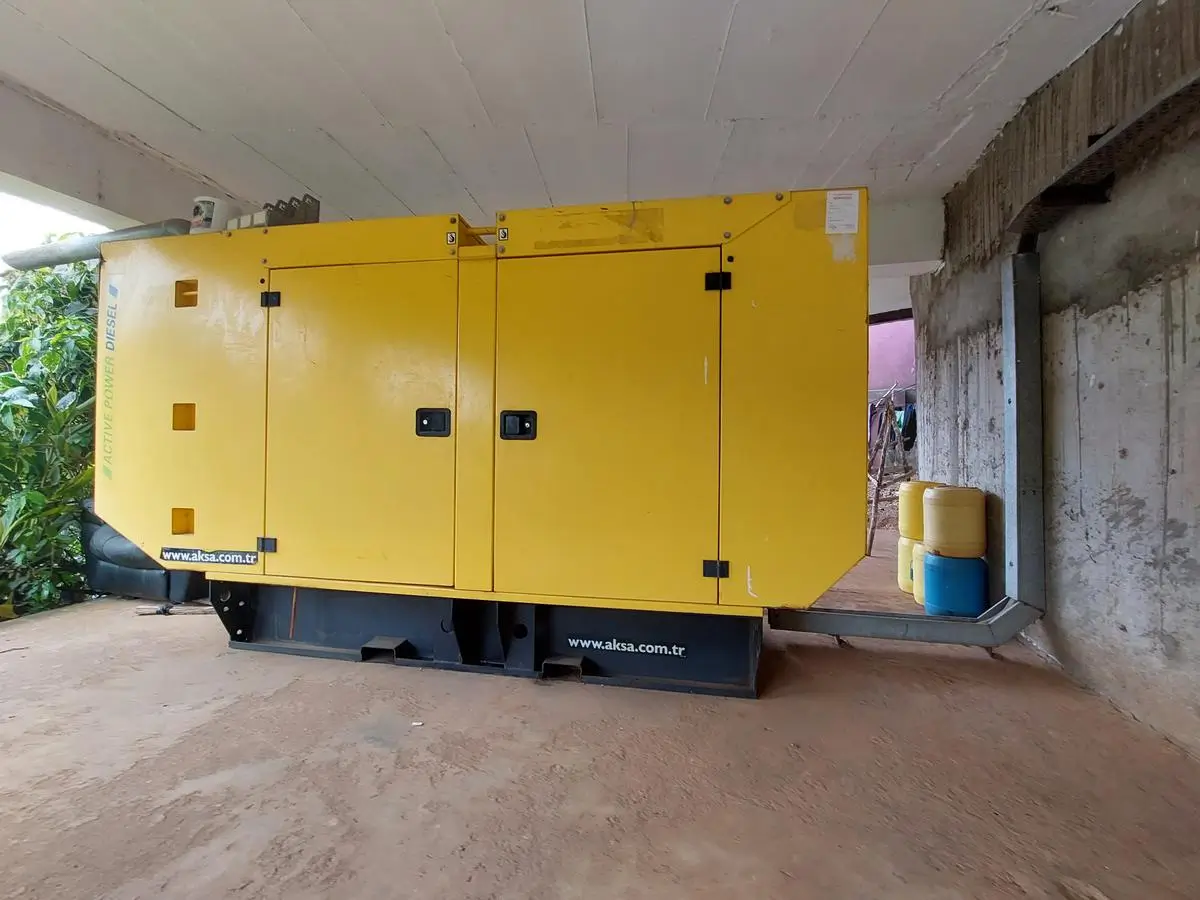 Yellow industrial generator unit under covered parking structure