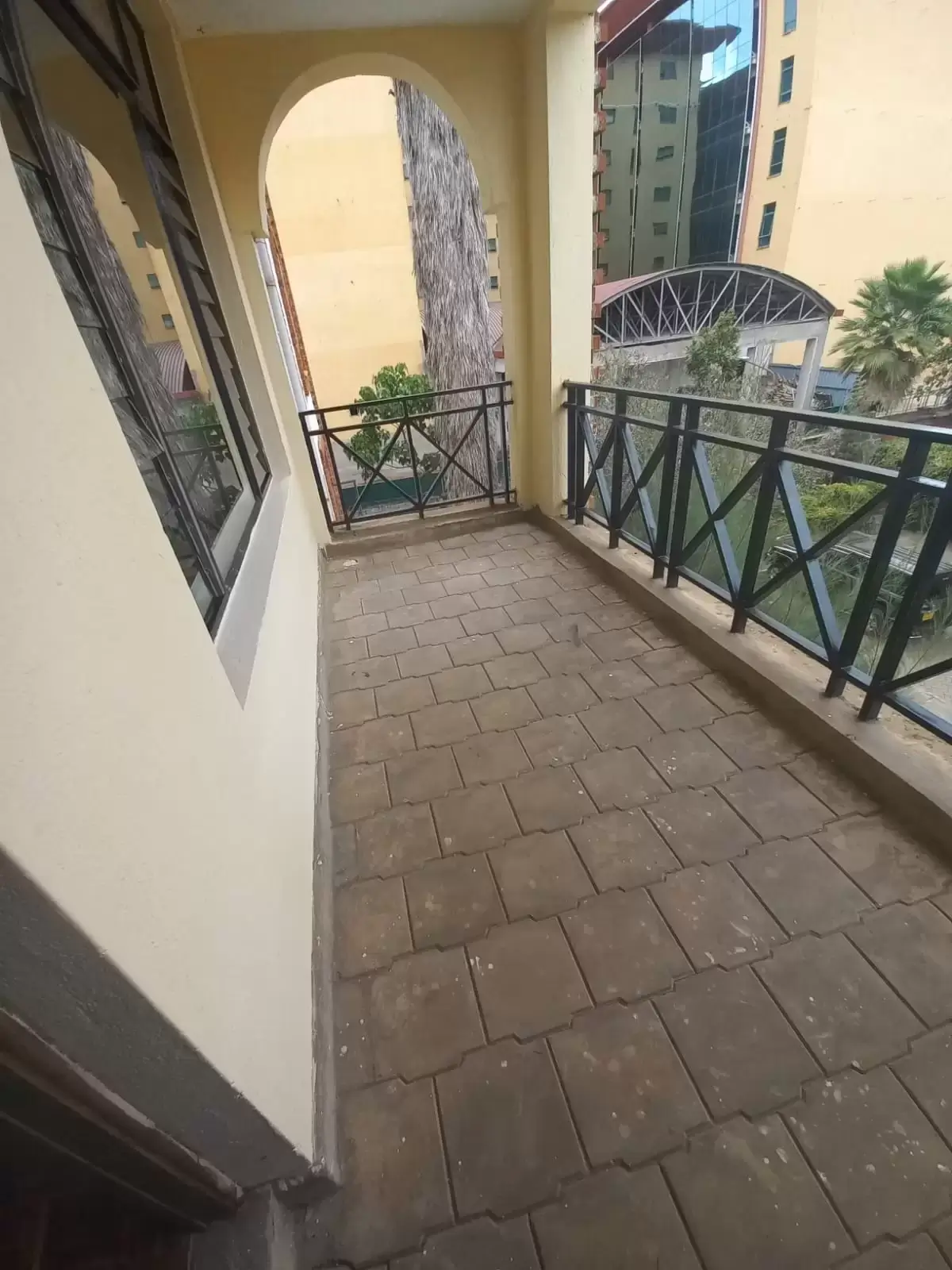 Spacious balcony with city views and metal railings