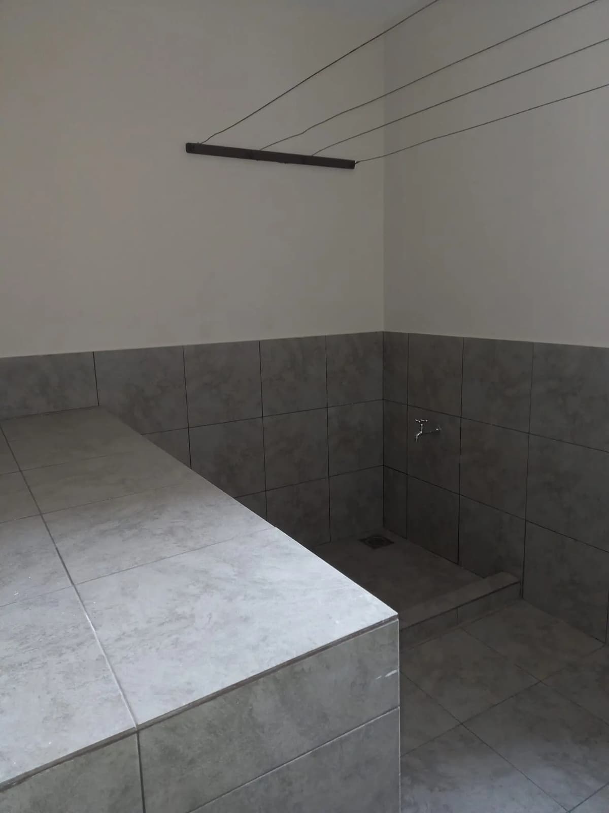 Bathroom with dark tile wainscoting and built-in bench seating