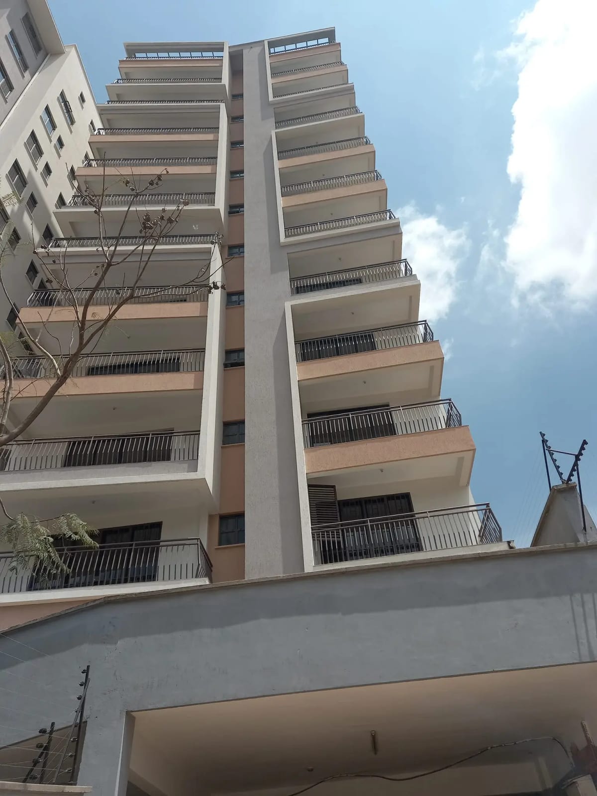 Modern multi-story residential building with balconies and facade