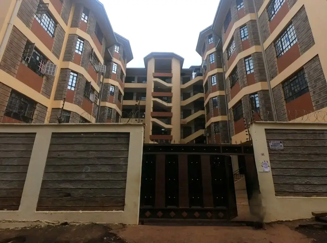 Multi-story apartment complex with ground-level garage gates