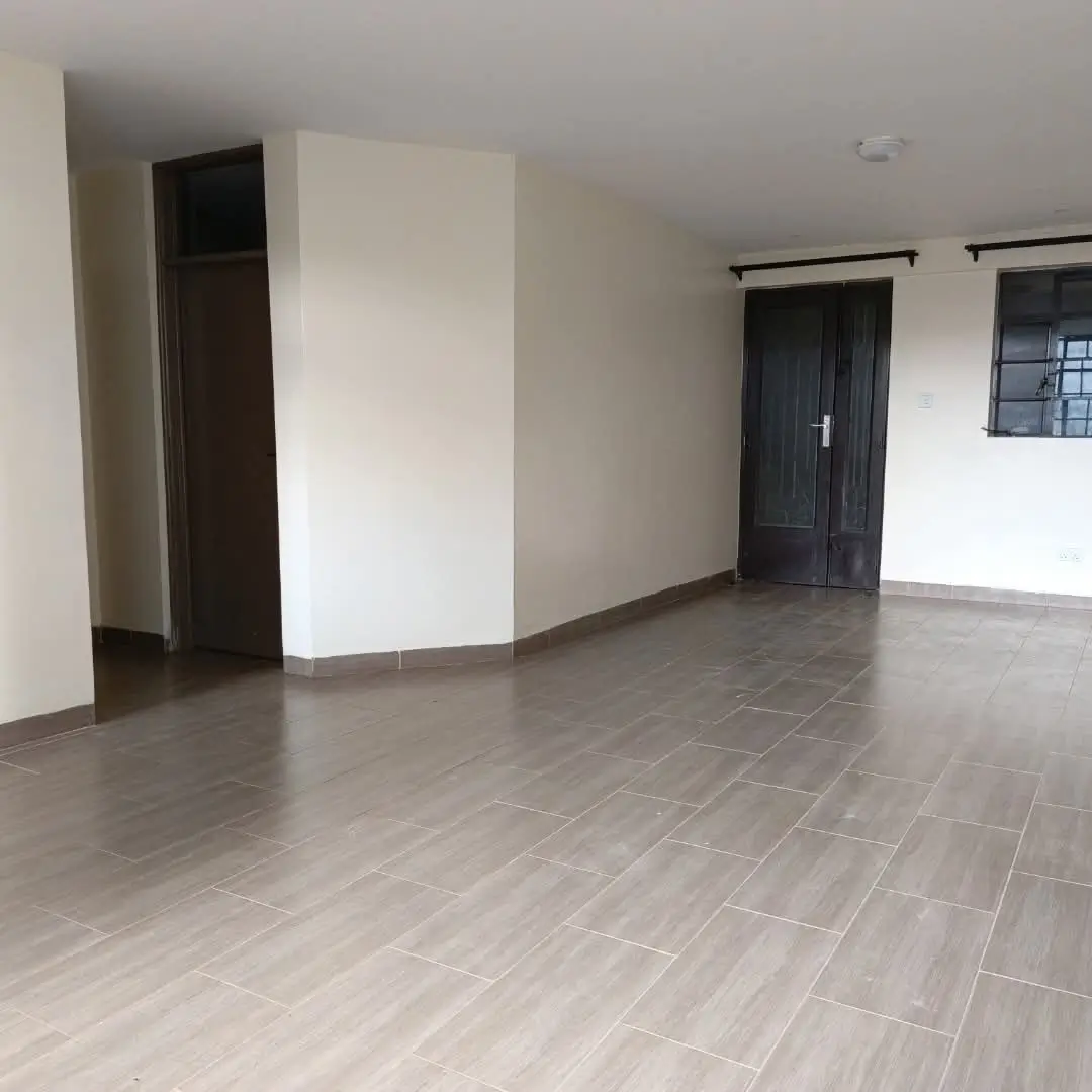 Spacious empty living room with grey tile flooring
