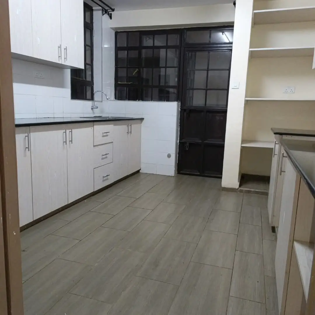 Modern kitchen with white cabinetry and open pantry shelving