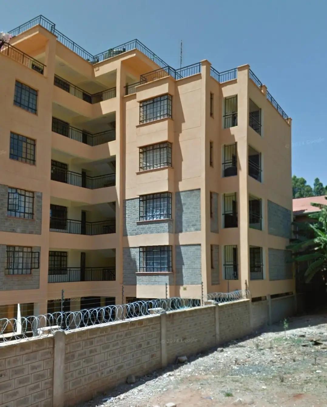 Multi-story residential building with cream facade and balconies