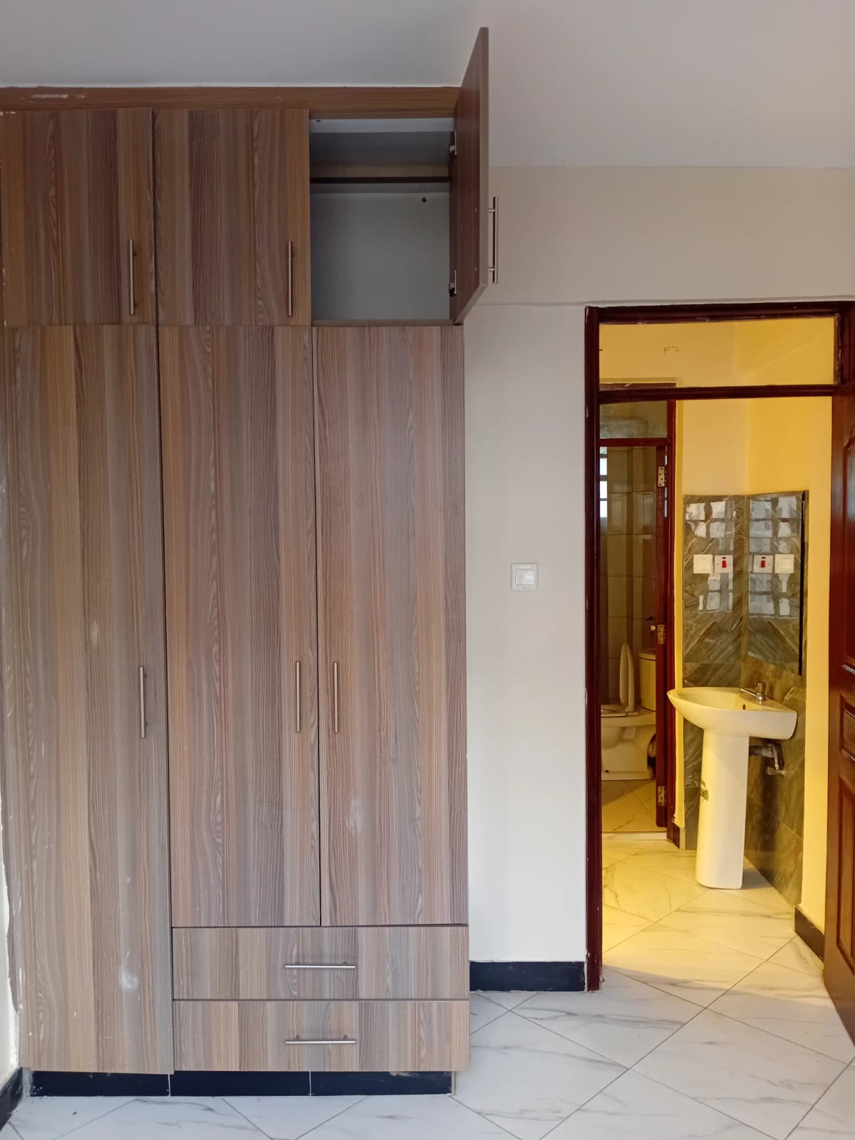 Bedroom with built-in wooden wardrobe and ensuite bathroom