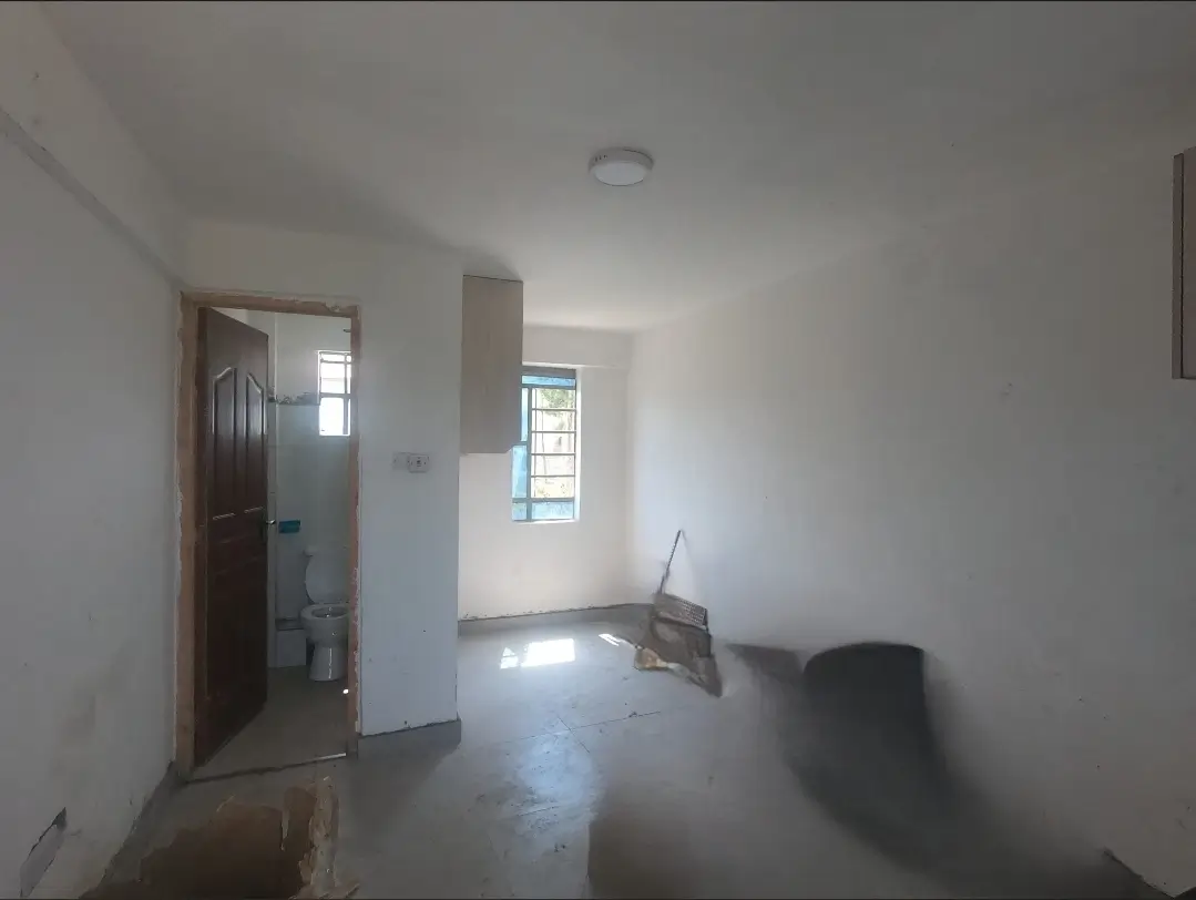 Empty living room with natural light, doorway to adjacent space