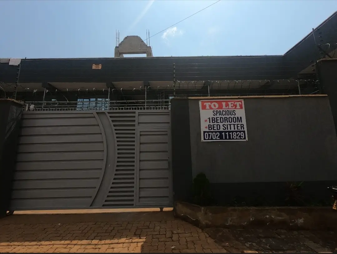 Property entrance with gate and TO LET sign visible