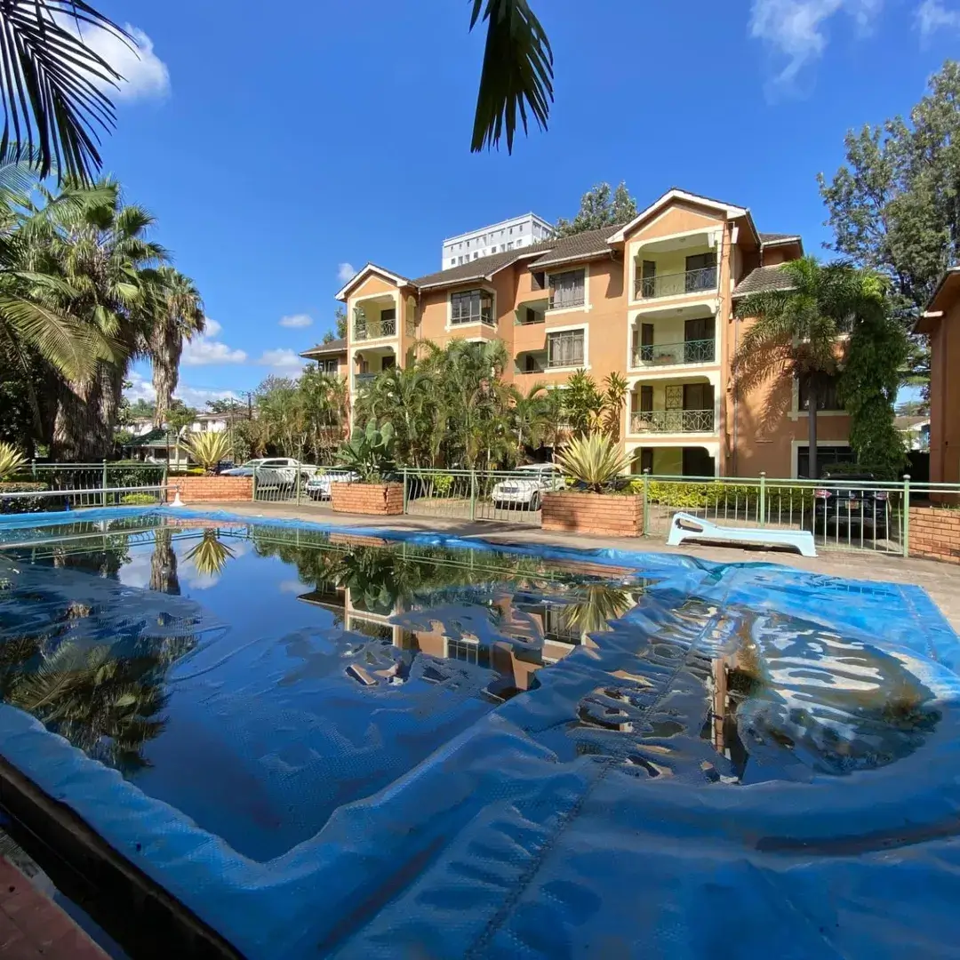 Resort-style swimming pool with apartment building backdrop