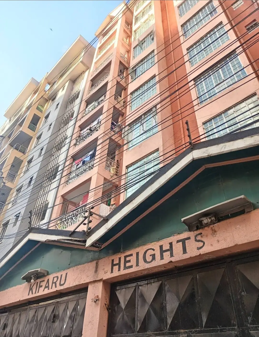 Multi-story residential building facade with retail storefront below