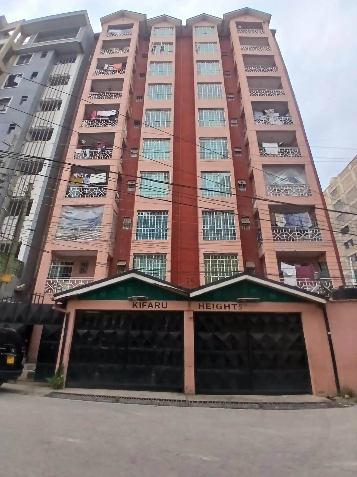Multi-story residential building with red brick facade and balconies