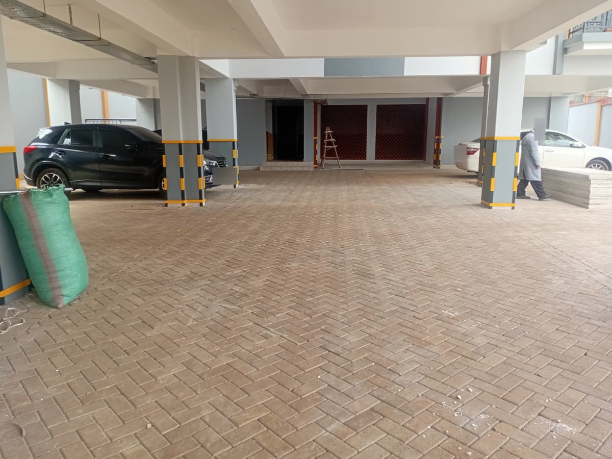 Covered basement parking with marked bays and yellow pillars