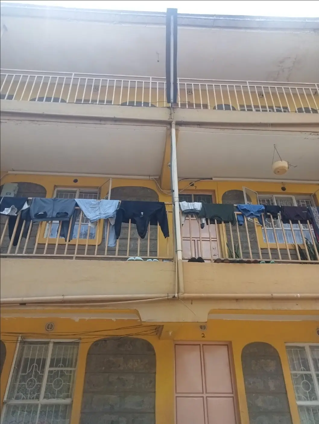 Multi-story residential building facade with laundry on balconies