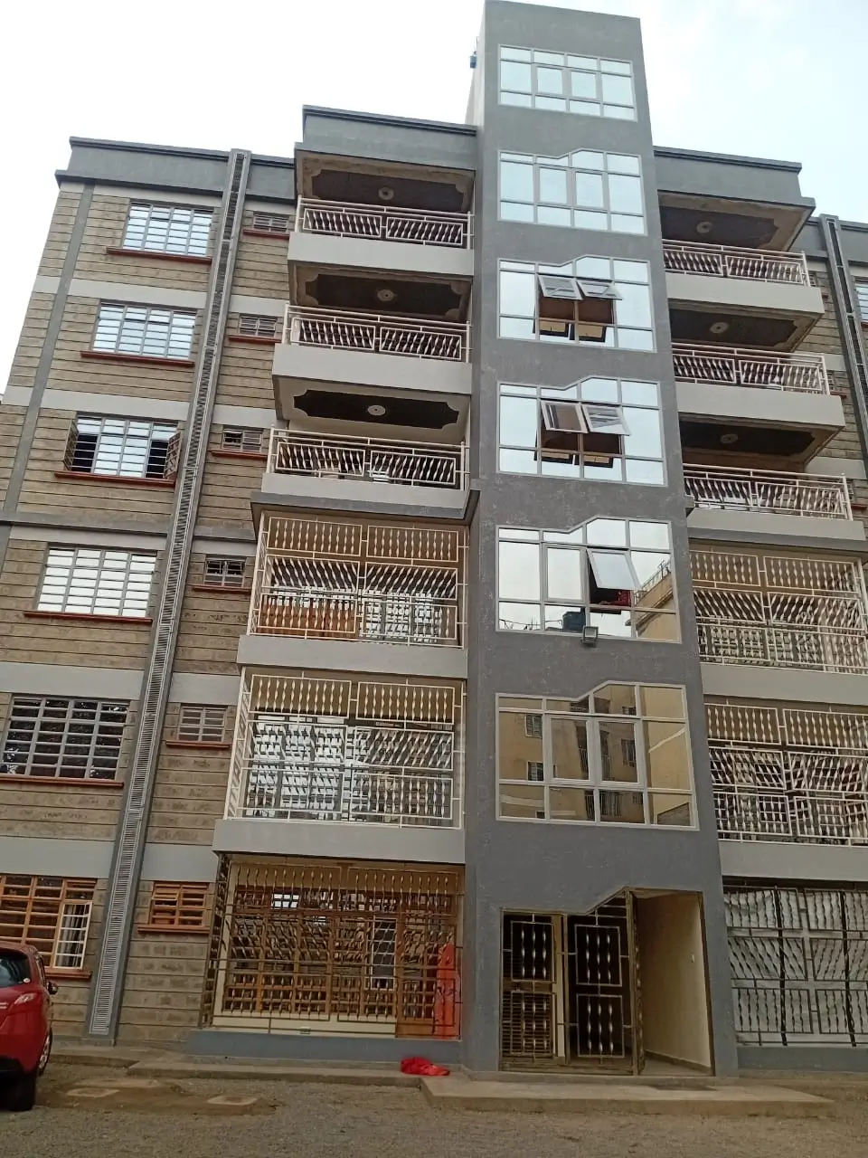 Multi-story residential building facade with balconies and entrance