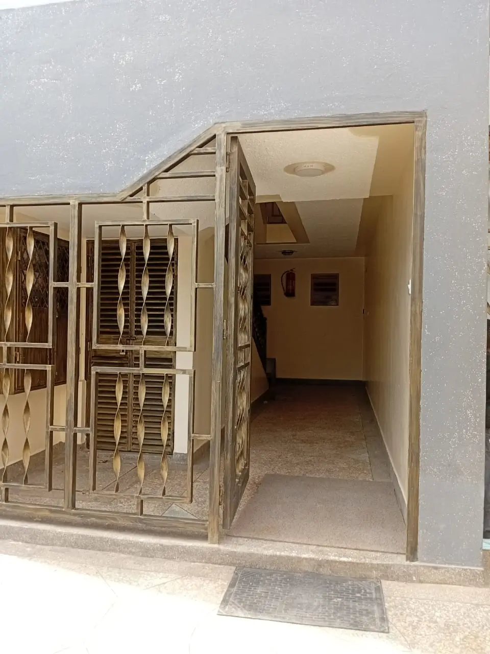 Metal gate entrance with corridor view beyond