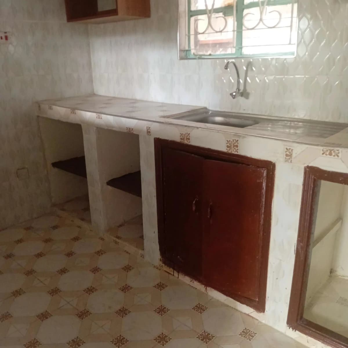 Basic kitchen with sink, counter space, red cabinets