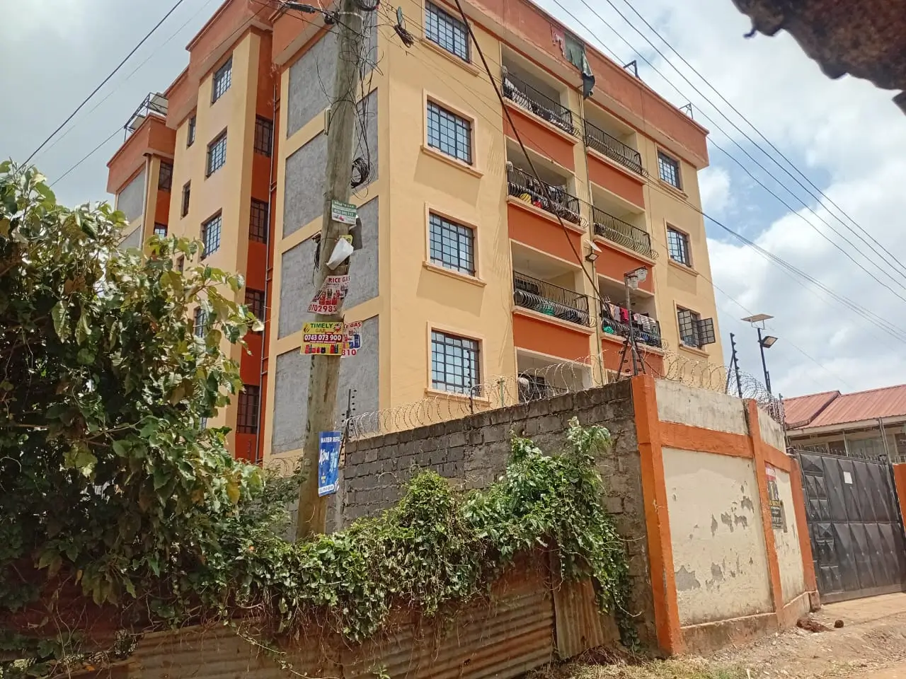Multi-story residential building with orange and yellow facade