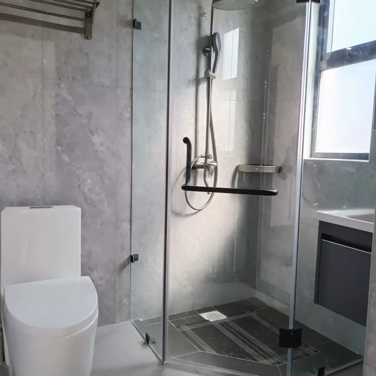 Modern bathroom with walk-in shower and white toilet