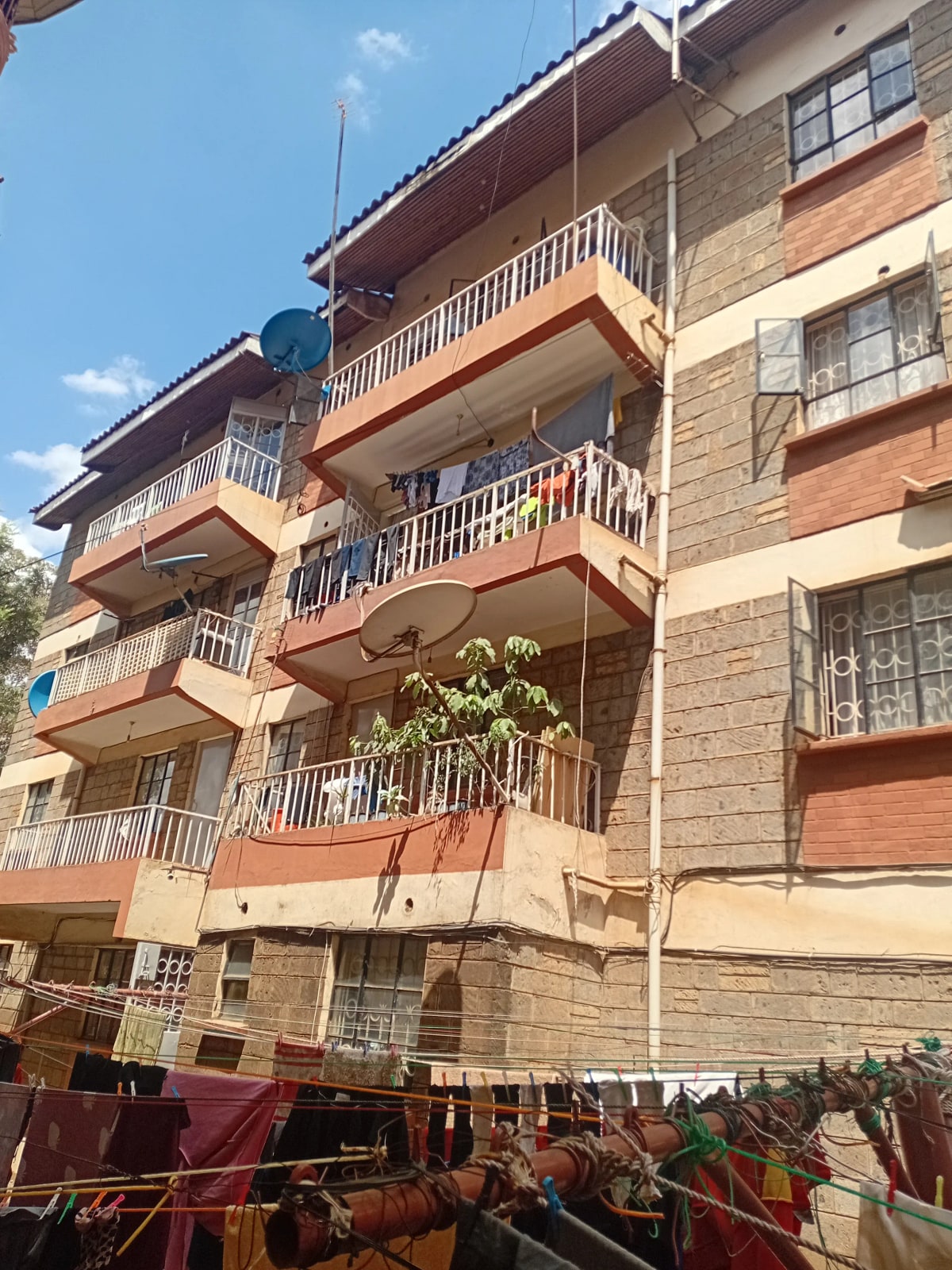 Multi-story residential building with balconies and brick facade
