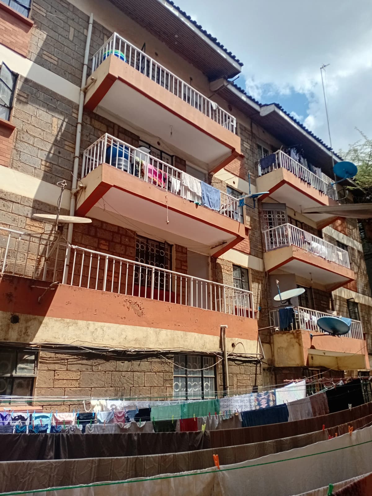 Multi-story residential building facade with balconies and clothesline