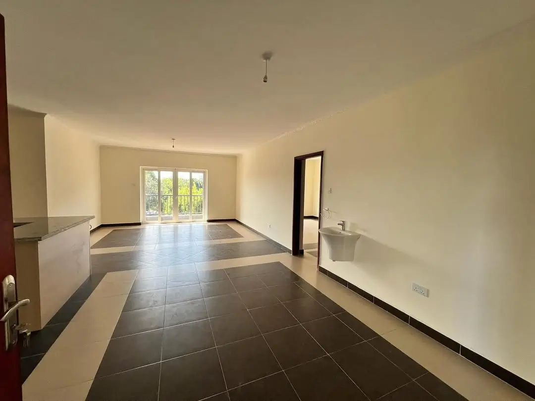 Spacious open-plan living area with dark tile flooring