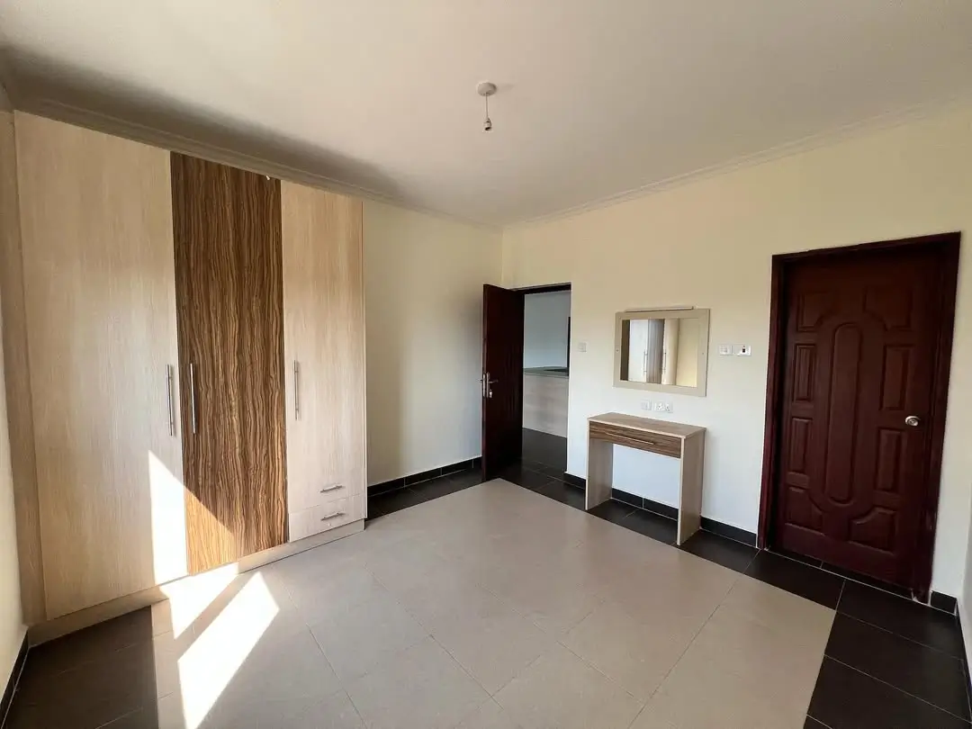 Spacious master bedroom with fitted wardrobes and ensuite access