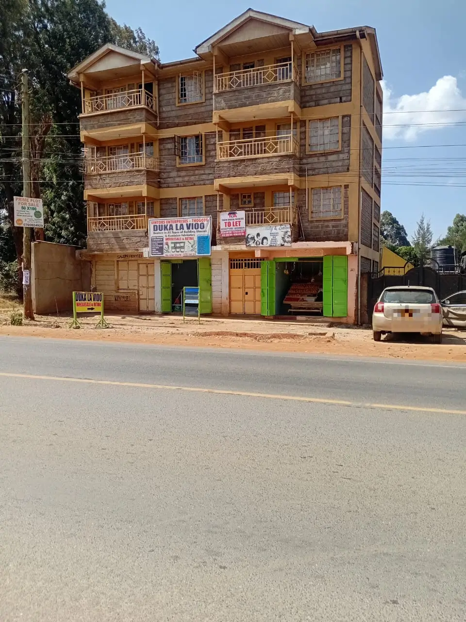 Multi-story residential building with wooden balconies and ground-floor shops