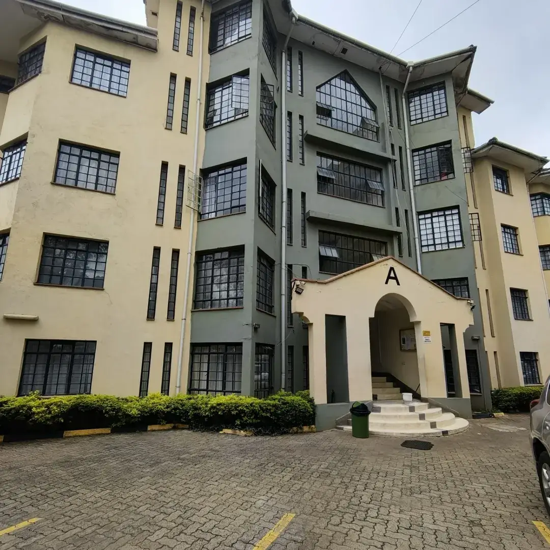 Multi-story residential building entrance with compound courtyard