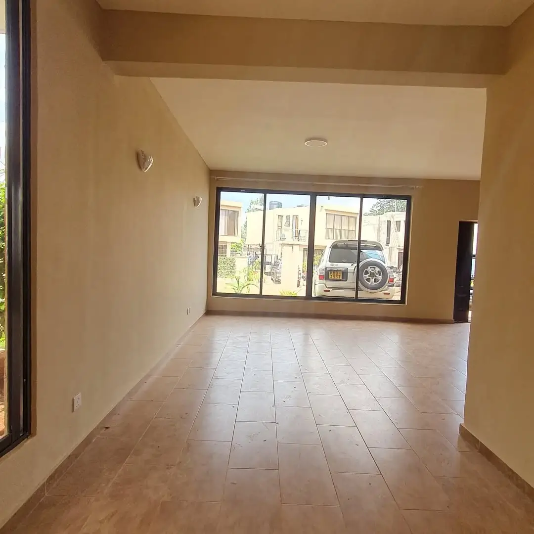 Spacious living room with tiled flooring and large windows