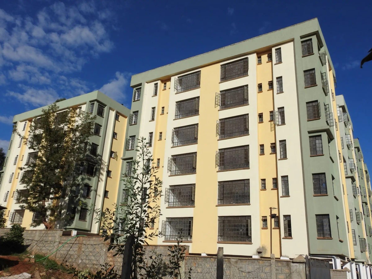Multi-story residential building with yellow and green facade
