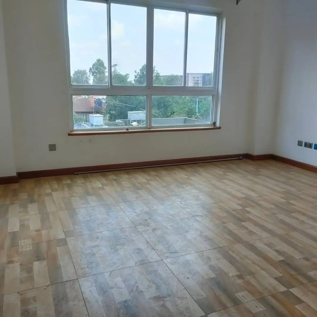 Spacious living room with wooden flooring and city views