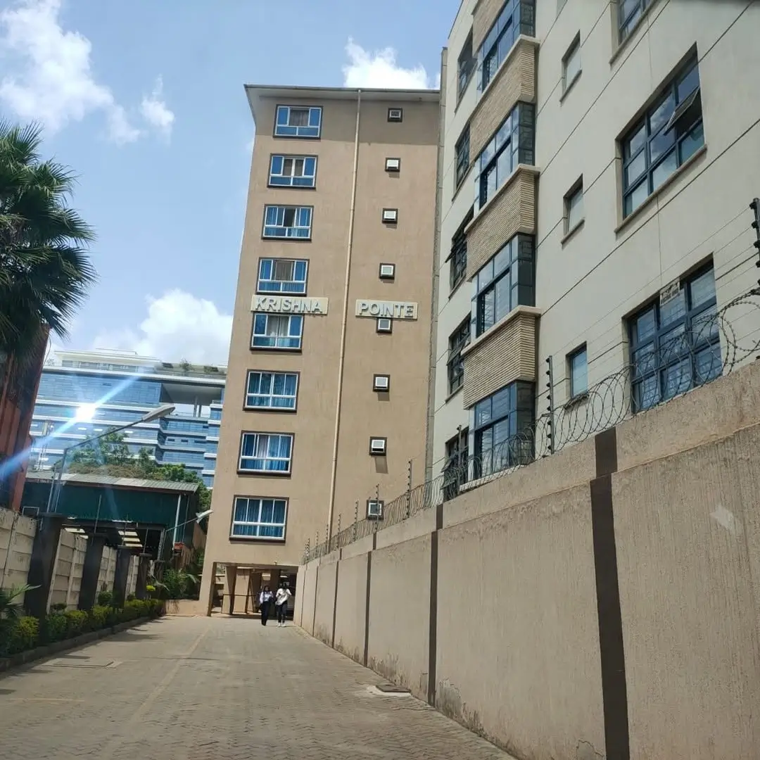 Multi-story residential building facade with blue window frames