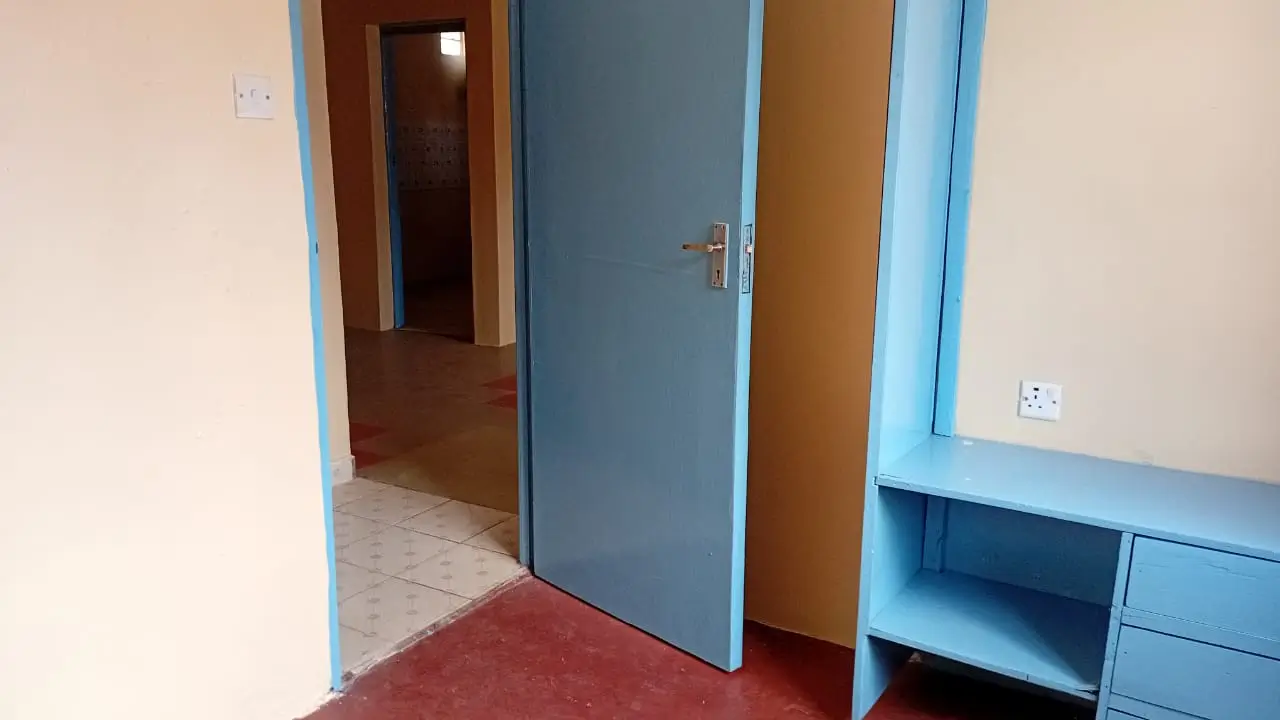 Building corridor with blue door and red floor mat