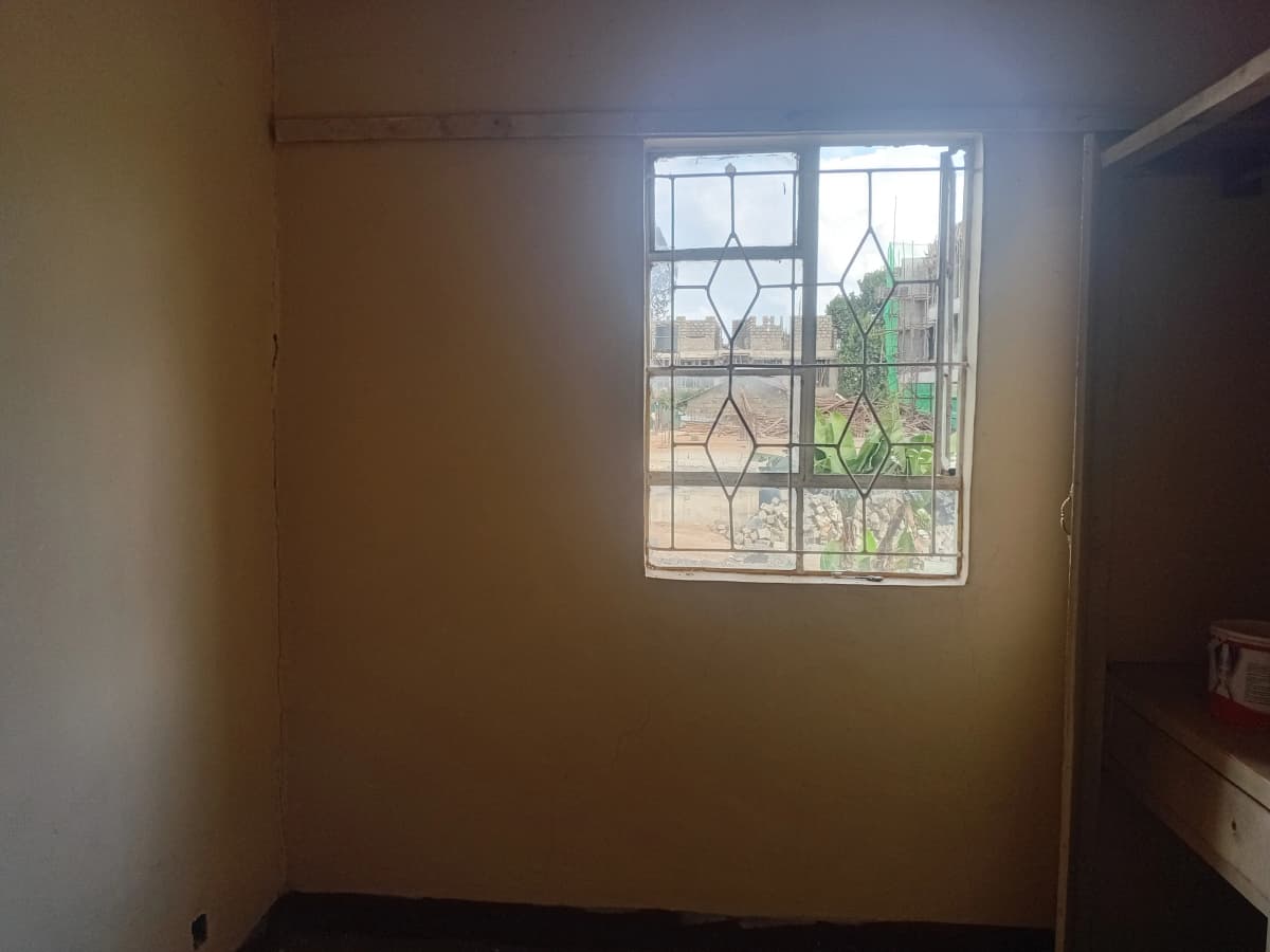 Simple bedroom with decorative window and natural light