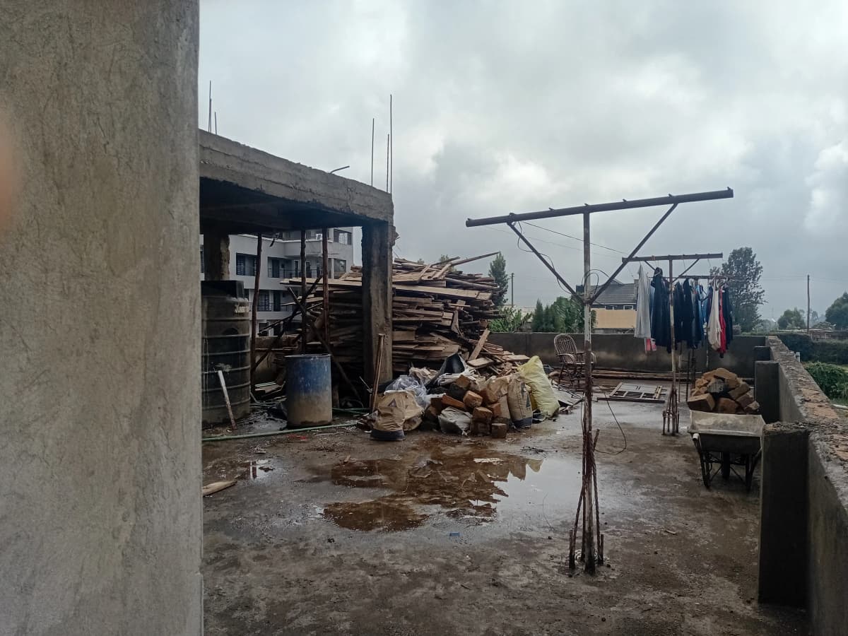 Construction site with scattered materials and utility structures