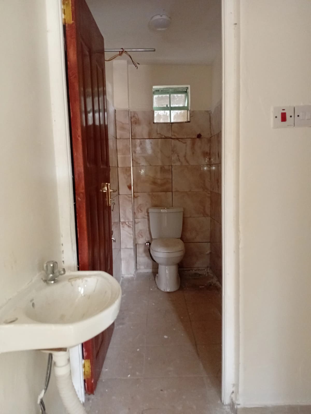 Bathroom with sink, toilet, tiled shower enclosure, window