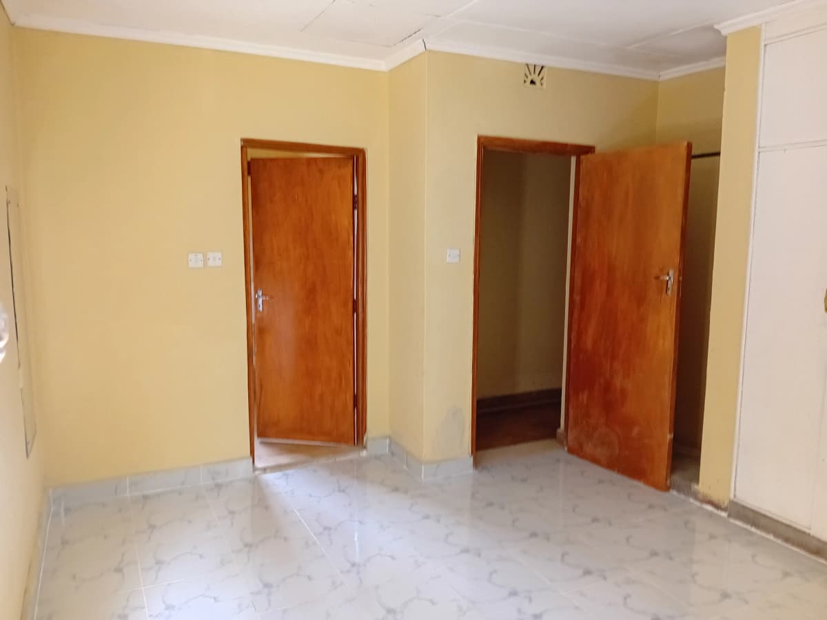 Empty living room with yellow walls and wooden doors