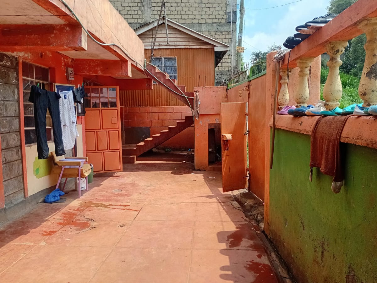 Compound courtyard with laundry lines and storage structures