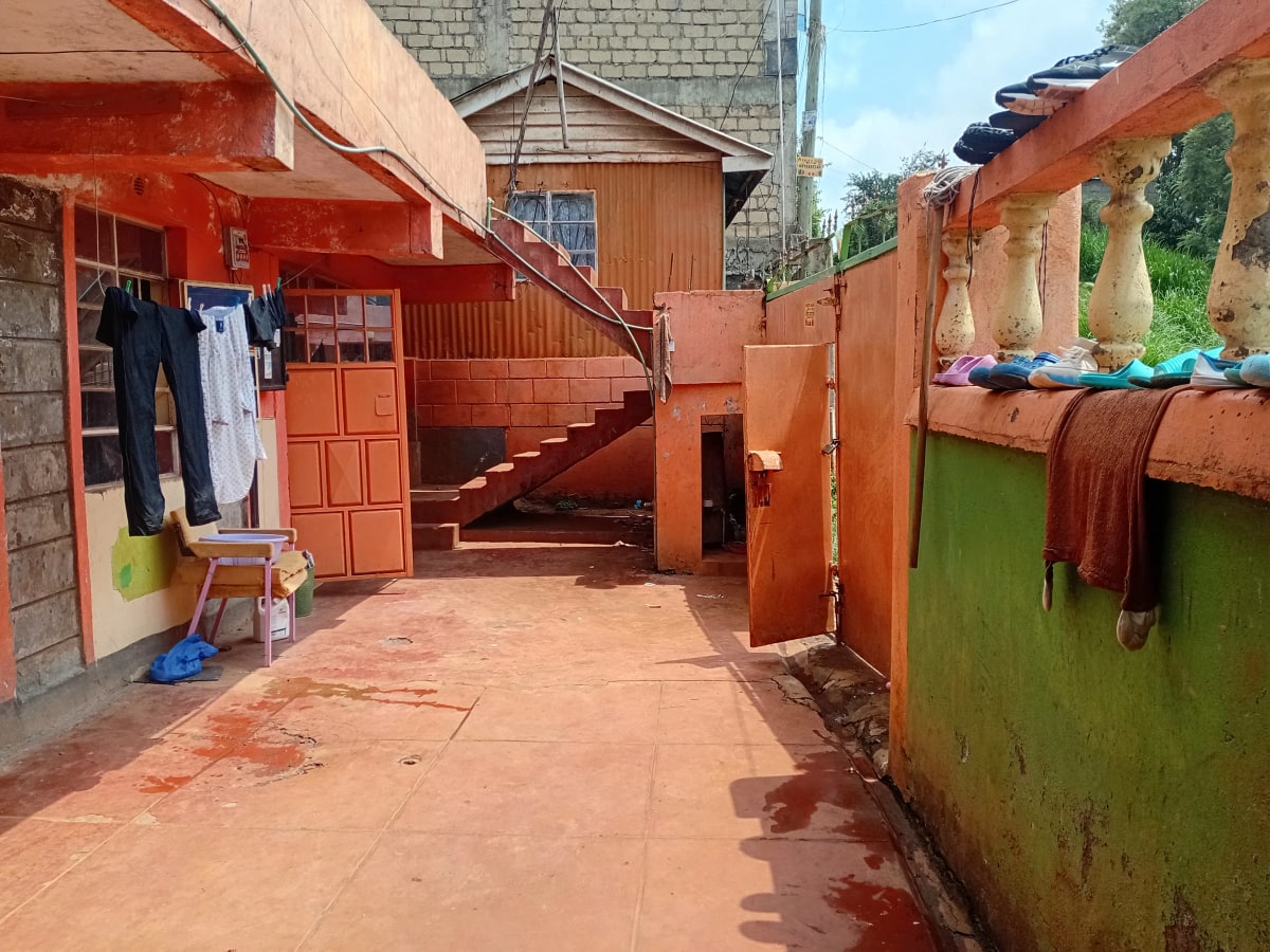 Compound courtyard with laundry lines and storage structures