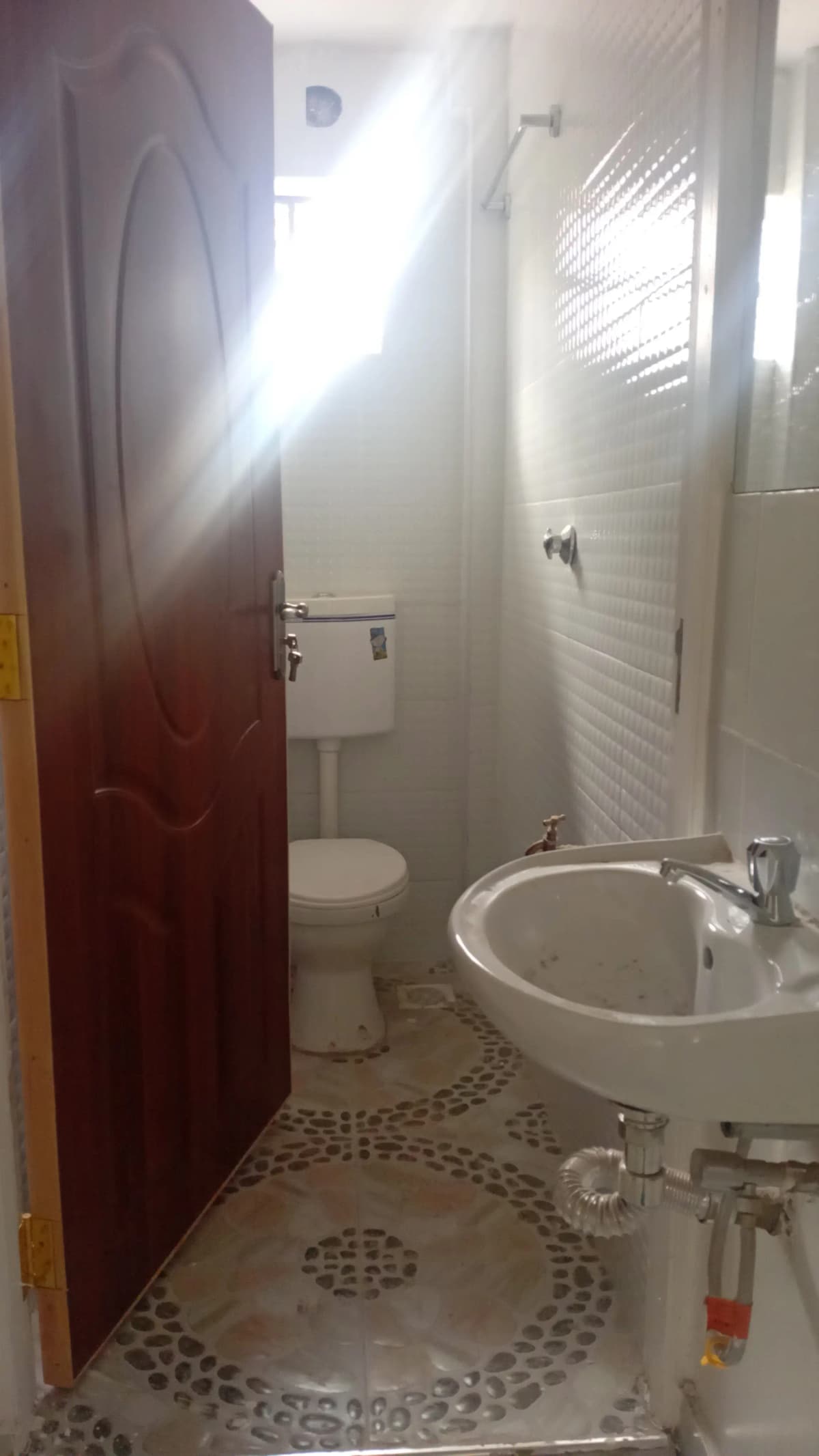 Compact bathroom with round sink and toilet