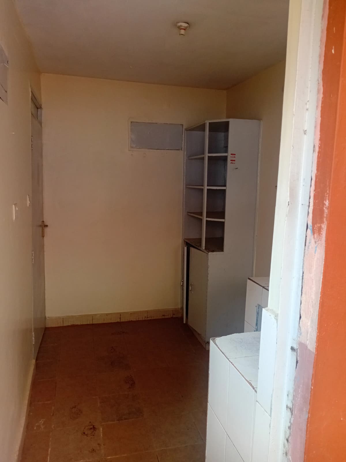 Unfurnished bedroom with built-in shelving and wooden flooring