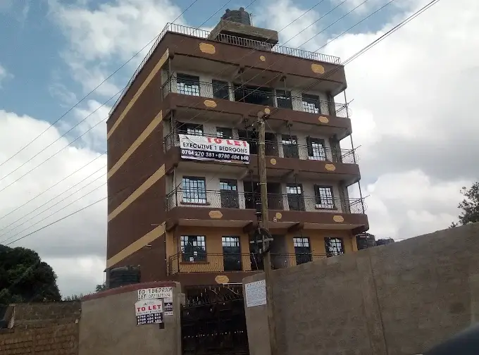 Multi-story residential building facade with brown brick exterior