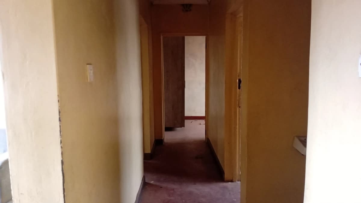 Interior hallway with wooden doors and burgundy carpet