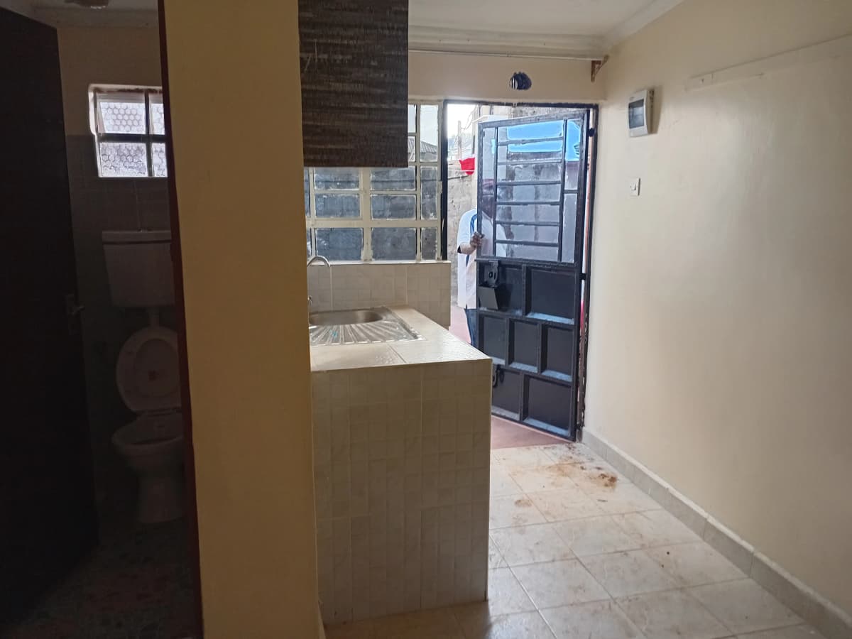 Building entrance hallway with kitchen counter and security door