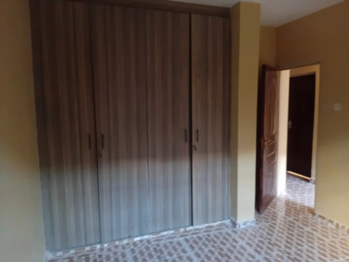 Bedroom with built-in wardrobe and tiled flooring